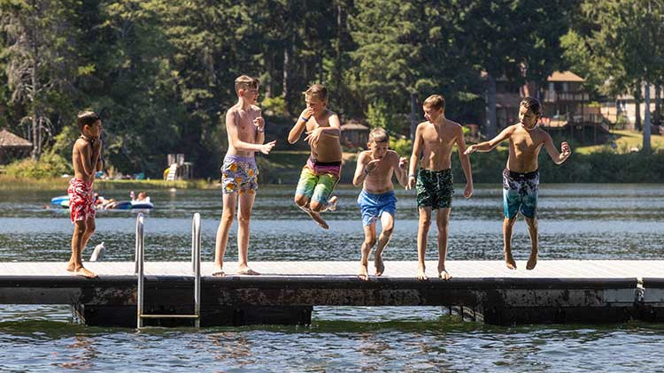 CRISTA Camps at Miracle Ranch - Boys jumping in lake