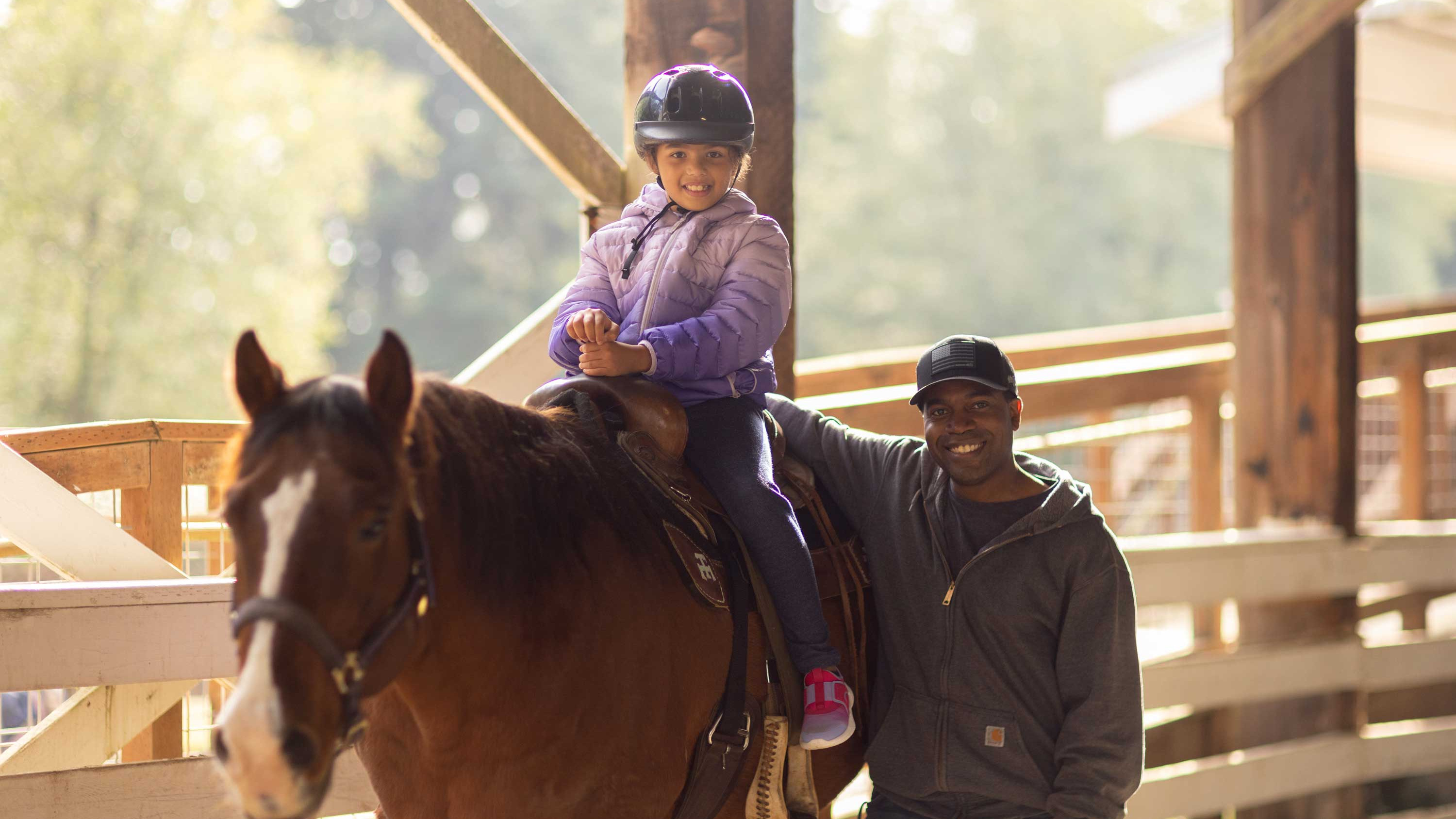 CRISTA Camps Family Camp - Girl Riding horse with Counselor by Her Side