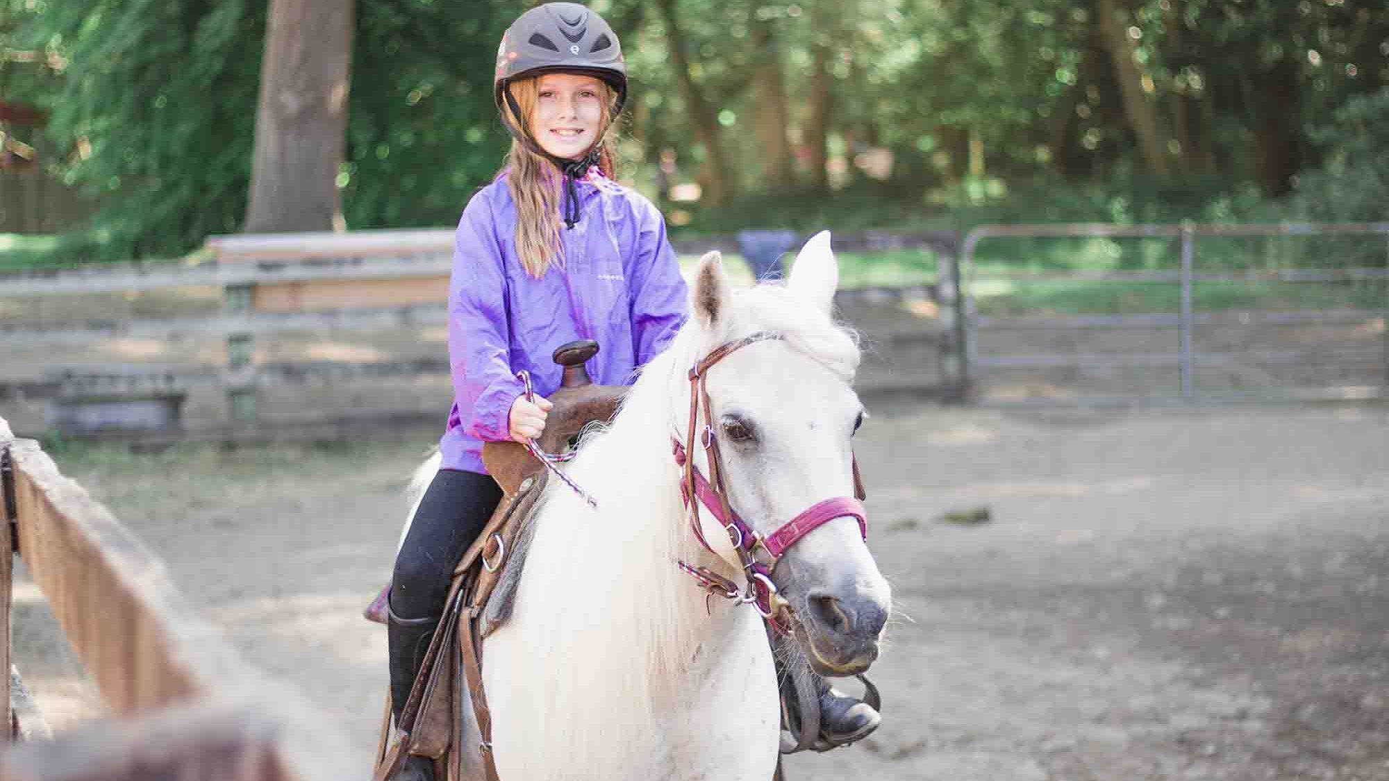 CRISTA Camps Horse Camp - Young Girl Getting Riding Lessons